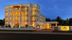 A multi-story hotel with a grand entrance, illuminated balconies, and a well-lit facade. - Daiwik Hotels Rameswaram (Rameshwaram)