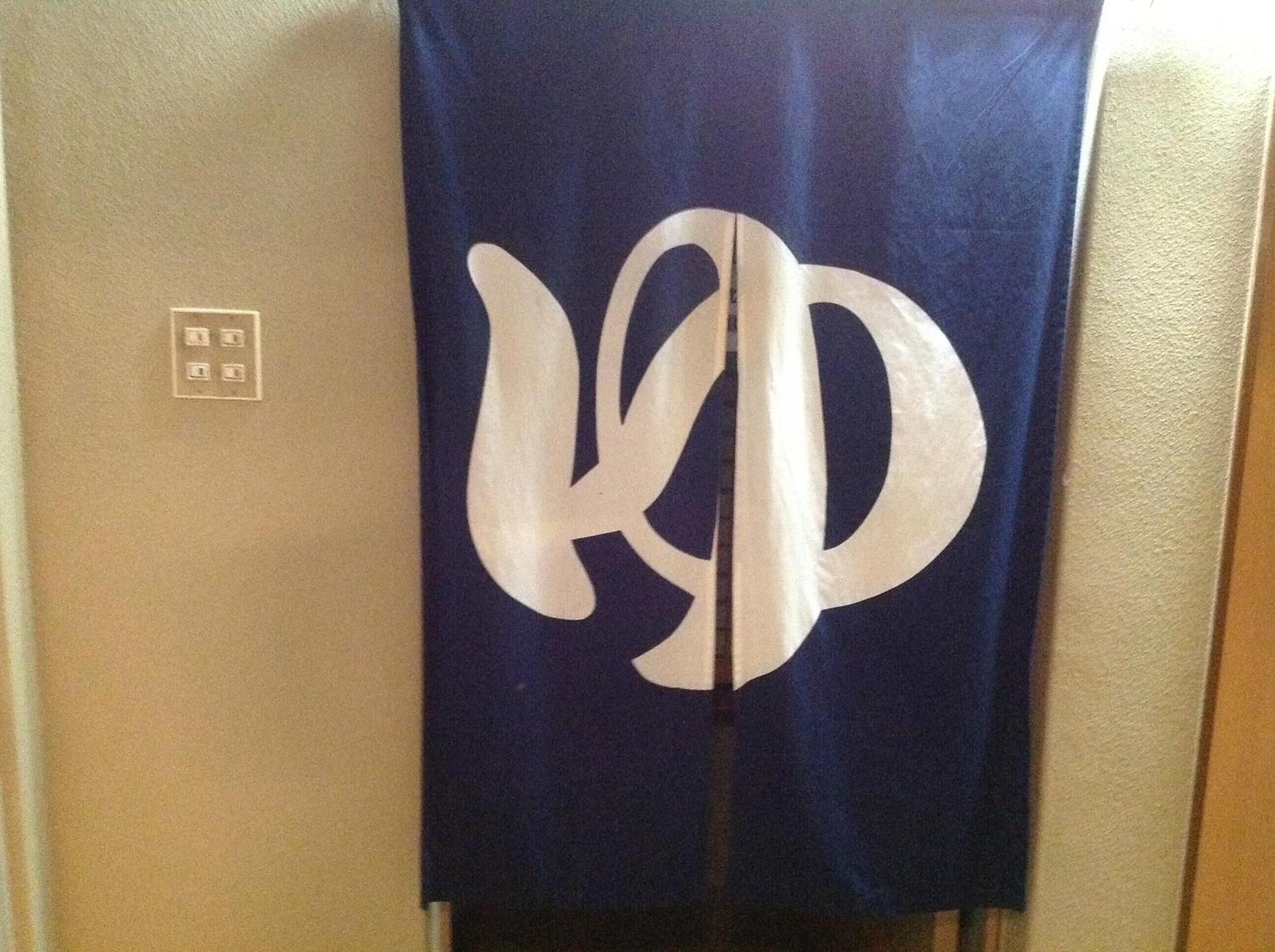 A blue elevator with a white logo.