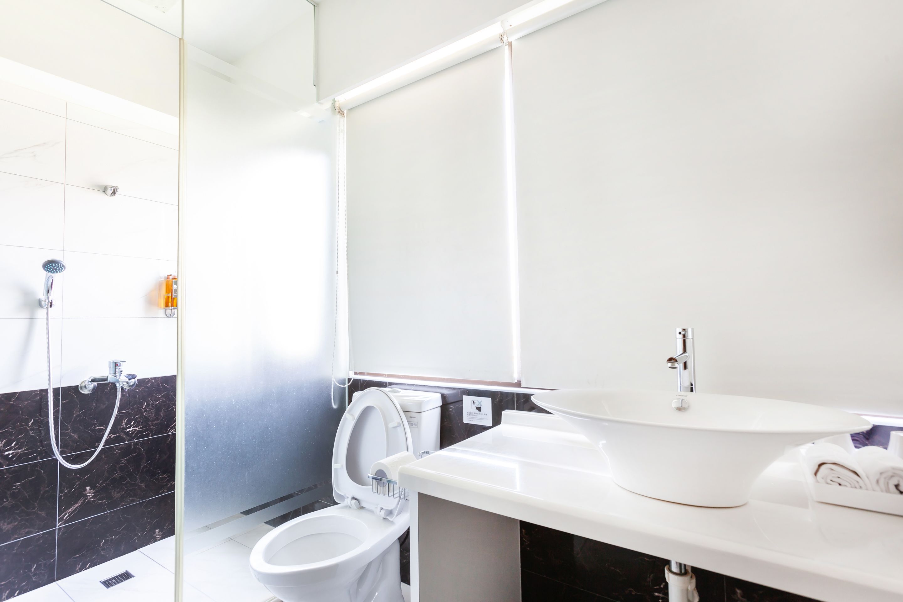 A modern bathroom with a toilet, bidet, and a sink.