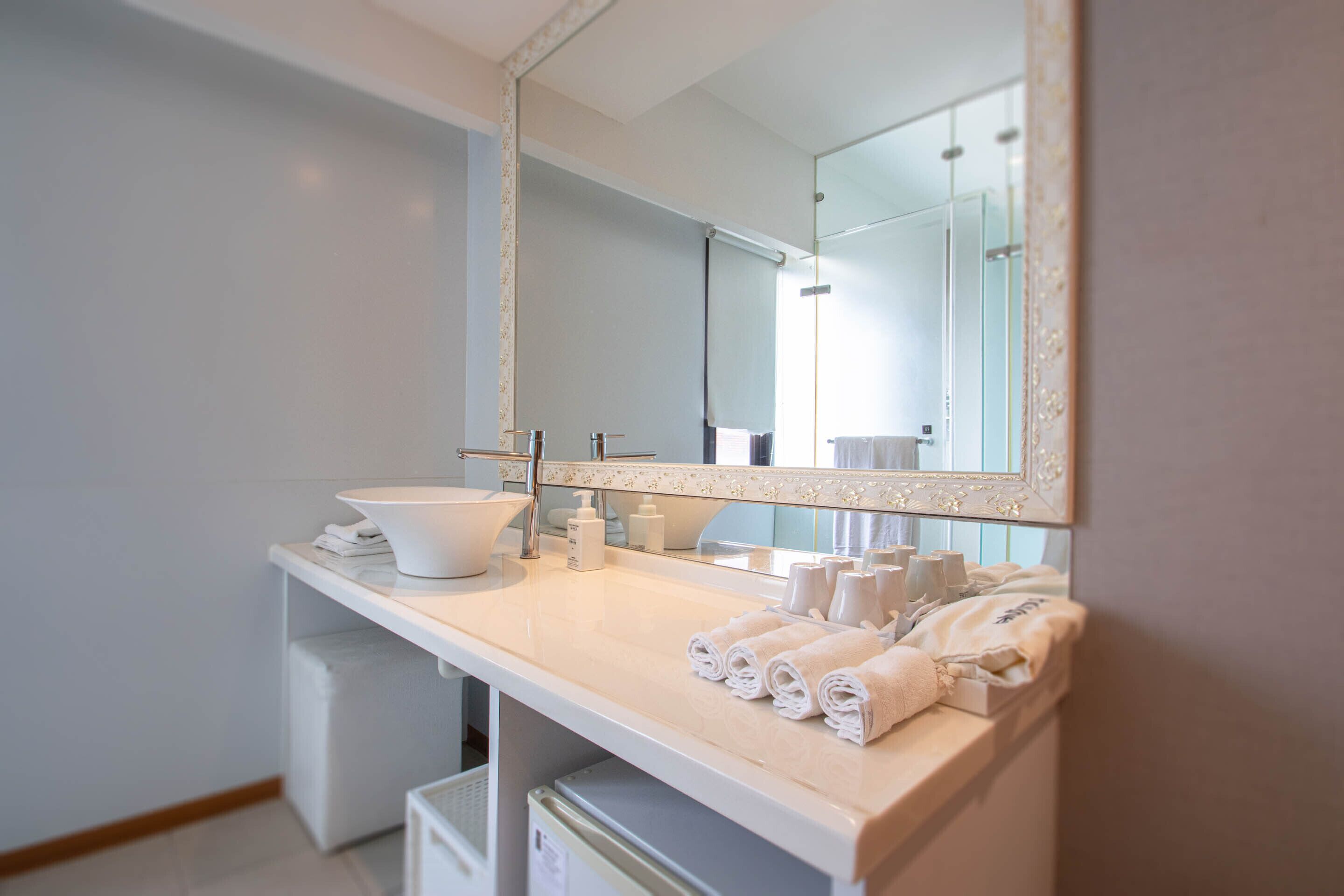 standard quadruple room | bathroom | shower, hair dryer, slippers, towels