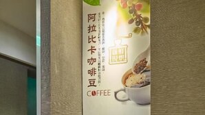 A coffee station with a coffee machine, cups, and a menu board advertising coffee. - StayInn Taipei (Taipei)