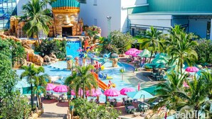 A water park with slides, pools, and umbrellas. - Happyland Mansion (Bangkok)
