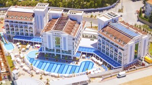 A hotel with multiple buildings, a swimming pool, and a parking area. - Diamond Elite Hotel & Spa - Adults Only (Manavgat)