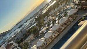 Un hotel sul lungomare con posti a sedere all'aperto e una piscina.