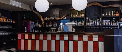A bar area with a checkered floor, a counter with a red and white striped design, and shelves stocked with bottles.