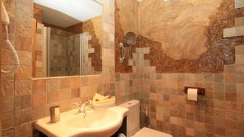 A bathroom with a sink, mirror, and toilet.