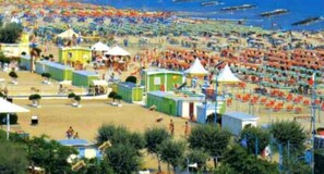 A beach with numerous tents and canopies, suggesting a temporary accommodation setup. - Hotel Villa Ersilia Rimini B&B (Rimini)