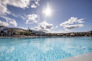 Outdoor pool, open 10:00 AM to 6:00 PM, pool umbrellas, sun loungers