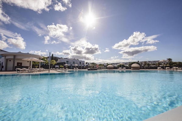 Outdoor pool, open 10:00 AM to 6:00 PM, pool umbrellas, sun loungers
