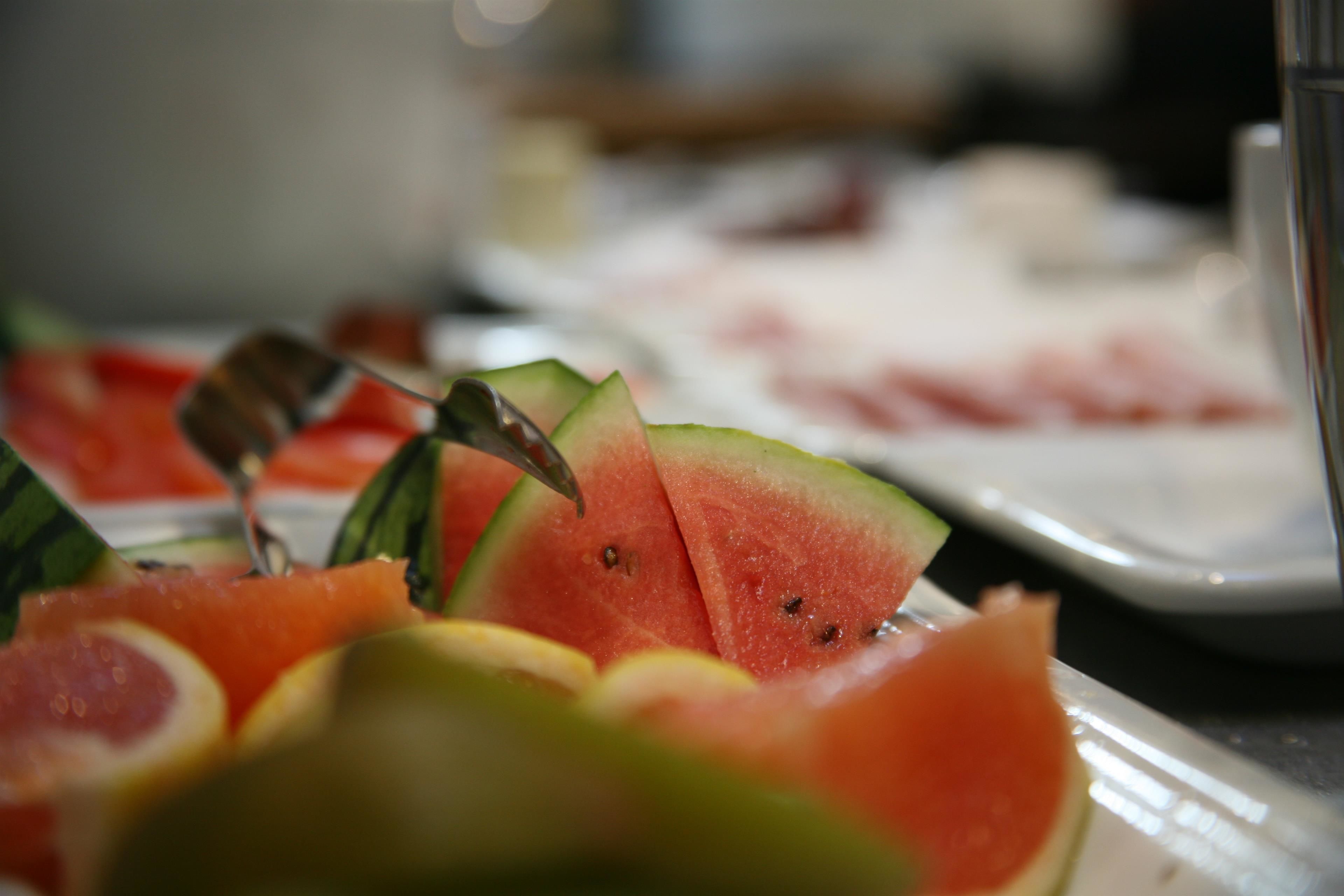 A close-up of watermelon slices with a fork.