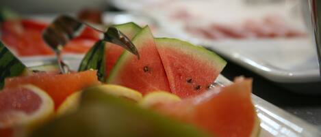 A close-up of watermelon slices with a fork.