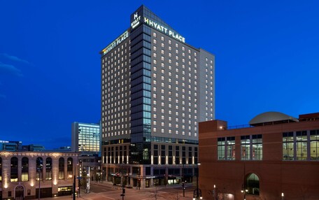 A multi-story hotel with a prominent "Hyatt Place" sign, large windows, and a modern architectural design.