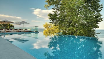 Seasonal outdoor pool, an infinity pool, pool umbrellas, sun loungers