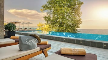 Seasonal outdoor pool, an infinity pool, pool umbrellas, pool loungers