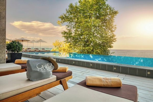 Seasonal outdoor pool, an infinity pool, pool umbrellas, sun loungers