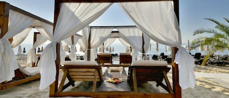 On the beach, beach cabanas, sun-loungers, beach umbrellas