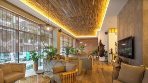A modern interior with a wooden ceiling, large windows, and various seating arrangements. - Grifid Hotel Vistamar - Ultra All Inclusive (Golden Sands)
