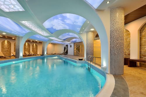 Indoor pool, outdoor pool, open 9 AM to 6 PM, pool umbrellas