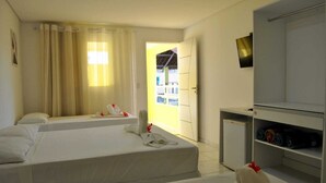 A hotel room with two beds, a wardrobe, and a view of the outside. - Pousada Jóia Rara (Ipojuca)