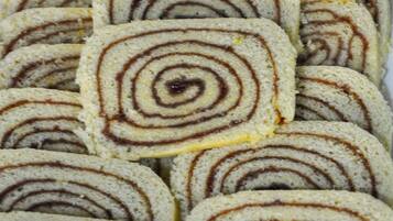 A tray of sliced pastries with a spiral pattern.