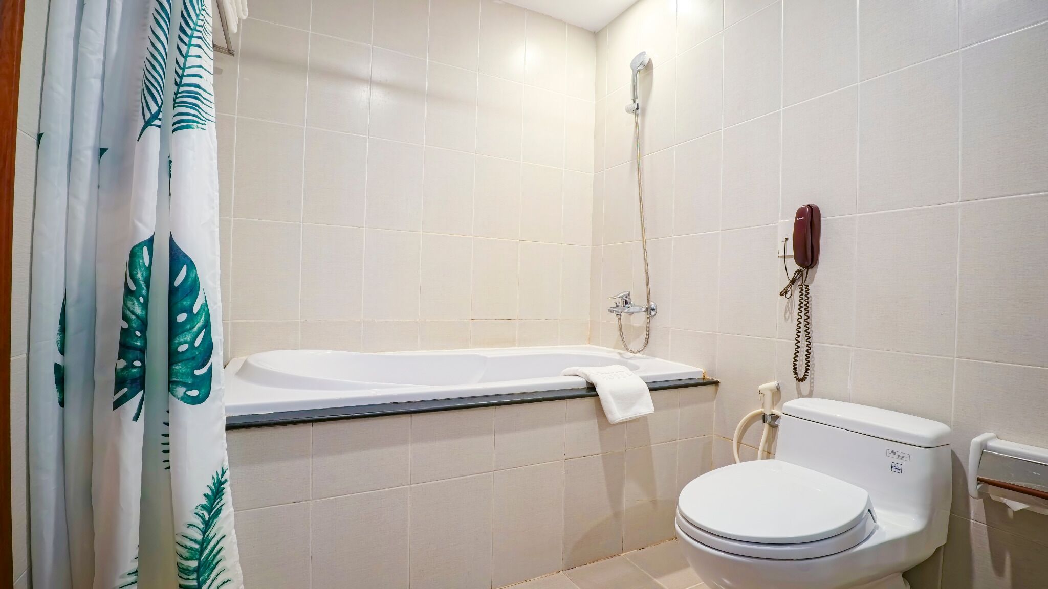 A bathroom with a bathtub, toilet, and a shower.