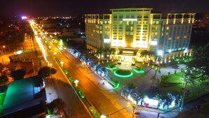 A multi-story hotel with a central courtyard, surrounded by a city street at night. - Sai Gon Rach Gia Hotel (Rach Gia)