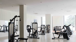 A gym with various exercise equipment, large windows, and a clean, modern design. - Sai Gon Rach Gia Hotel (Rach Gia)
