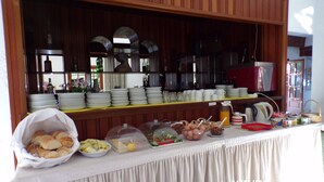 A buffet setup with various food items and dishes. - Sunlight Hotel (Agios Vasileios)