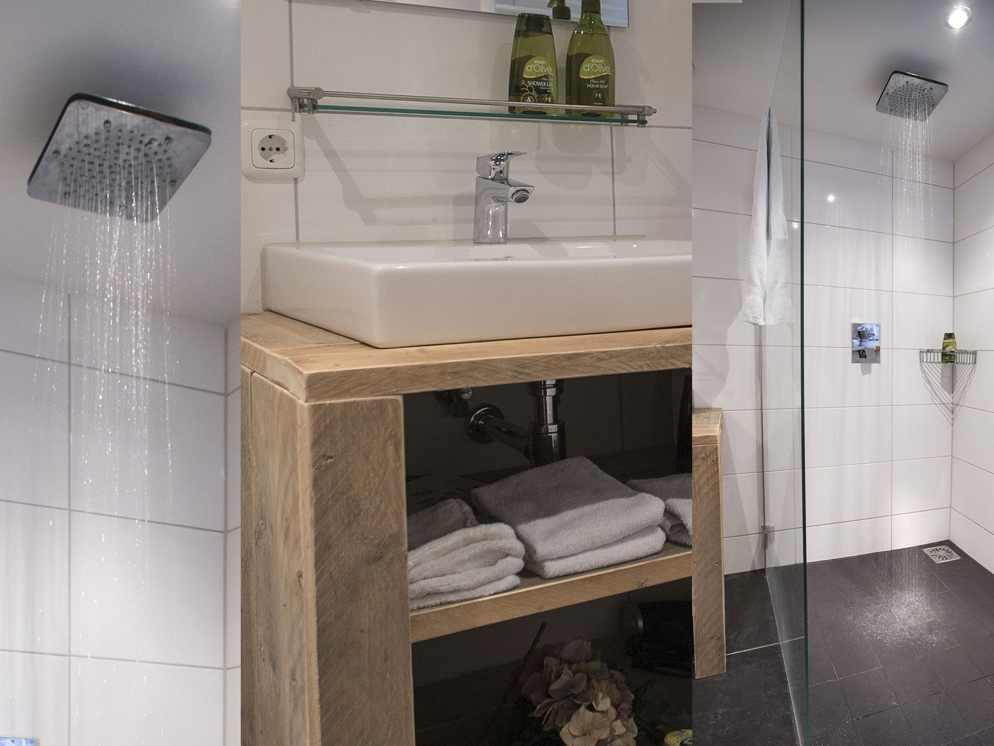 Een moderne badkamer met een douche, wastafel en een glazen plank.