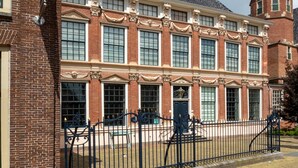 A historic building with a symmetrical facade, large windows, and a central entrance with a decorative door. - City Guesthouse De Rozenboom (Leeuwarden)