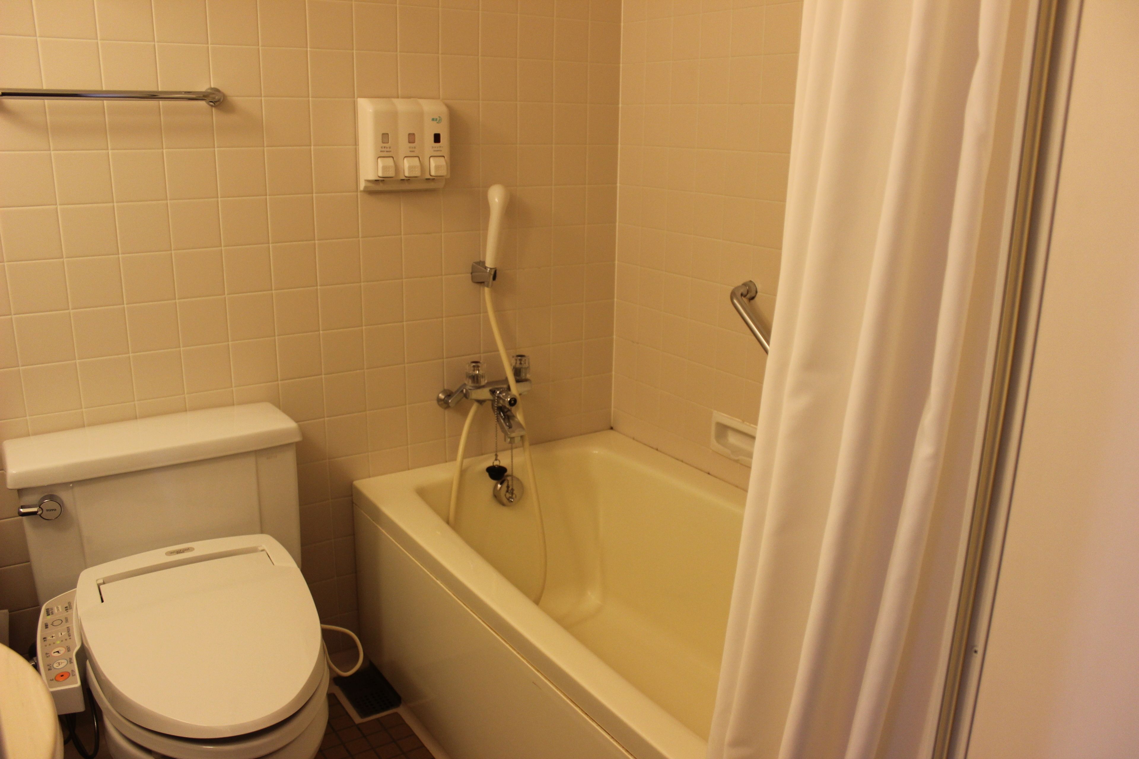 deep-soaking bathtub, hair dryer, slippers, bidet