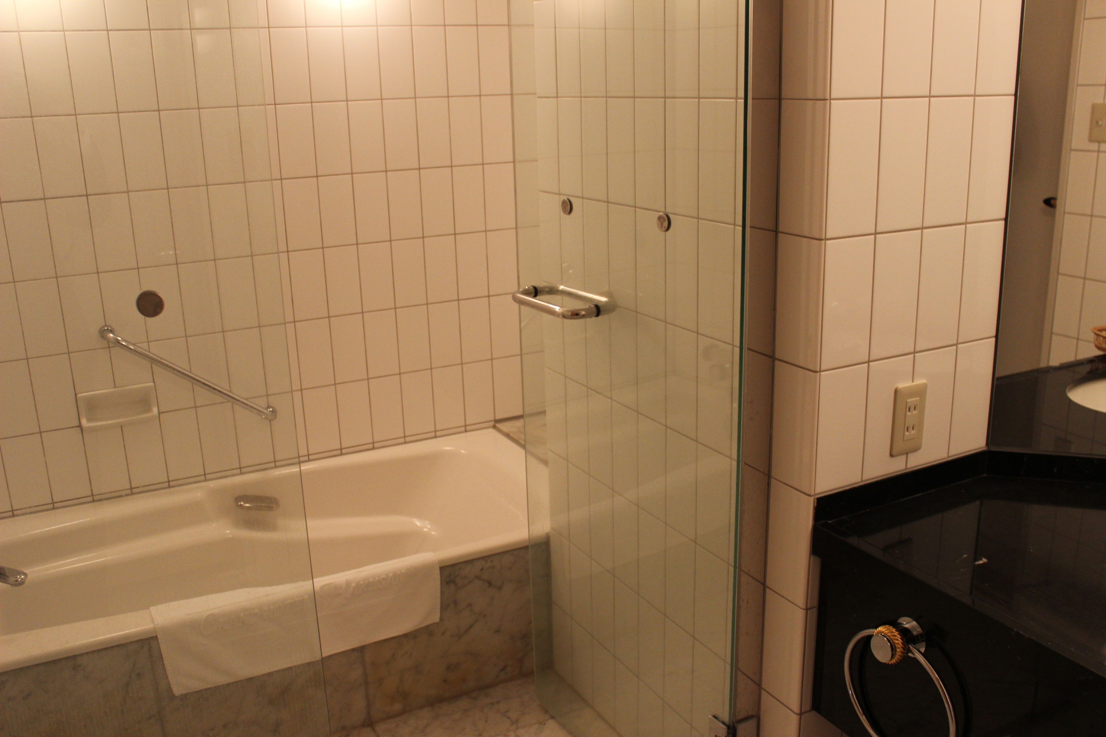 junior suite | bathroom | deep-soaking bathtub, hair dryer, slippers, bidet