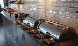 A buffet setup with multiple self-service stations, each equipped with a toaster and serving utensils.