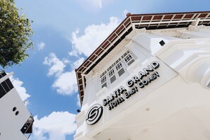 The exterior of the Santa Grand Hotel East Coast with a clear sky and clouds in the background. - Santa Grand Hotel East Coast, a NuVe Group Collection (Singapore)