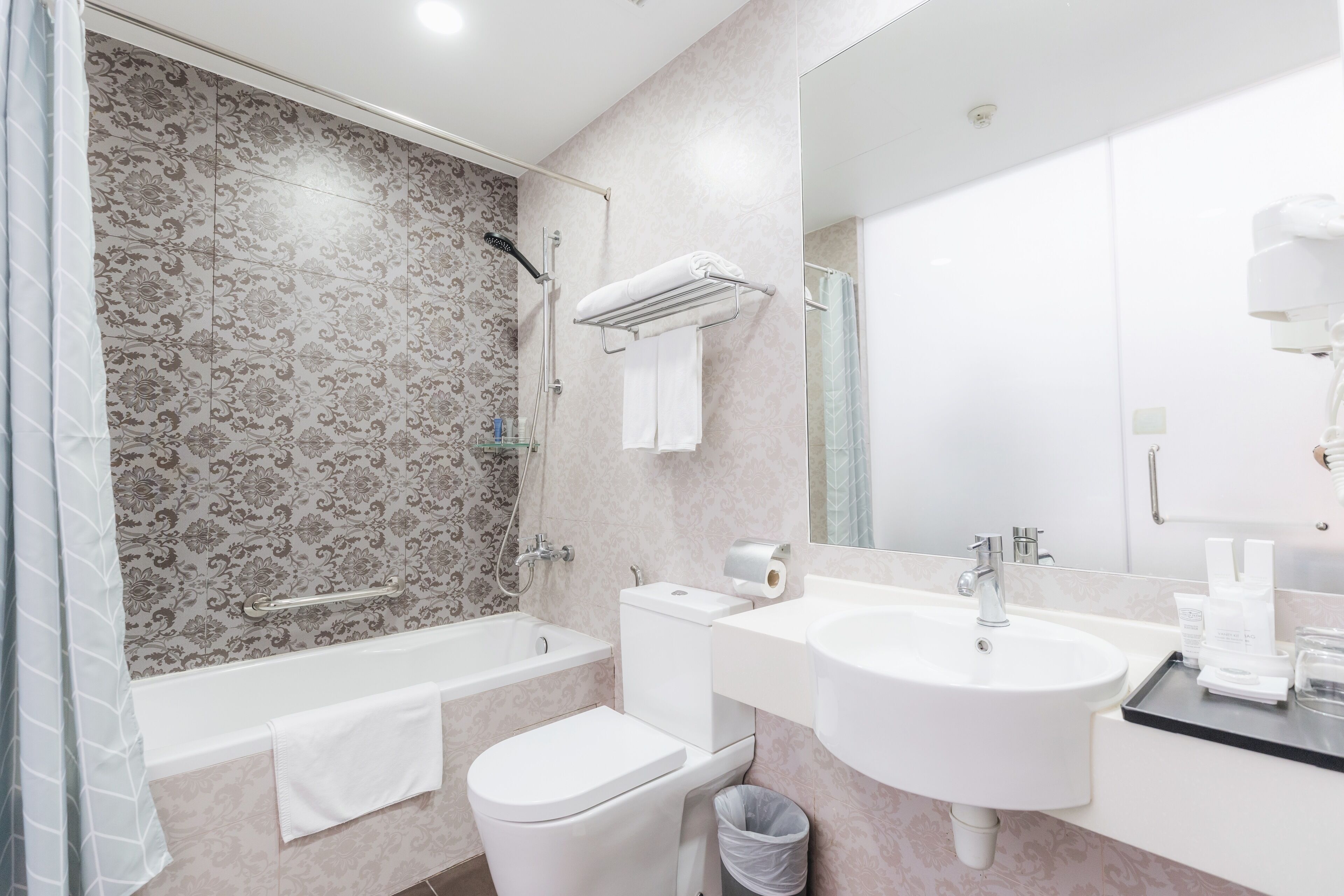 A modern bathroom with a bathtub, toilet, and sink.