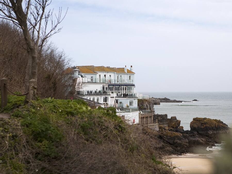 A coastal building with multiple balconies overlooking the sea.