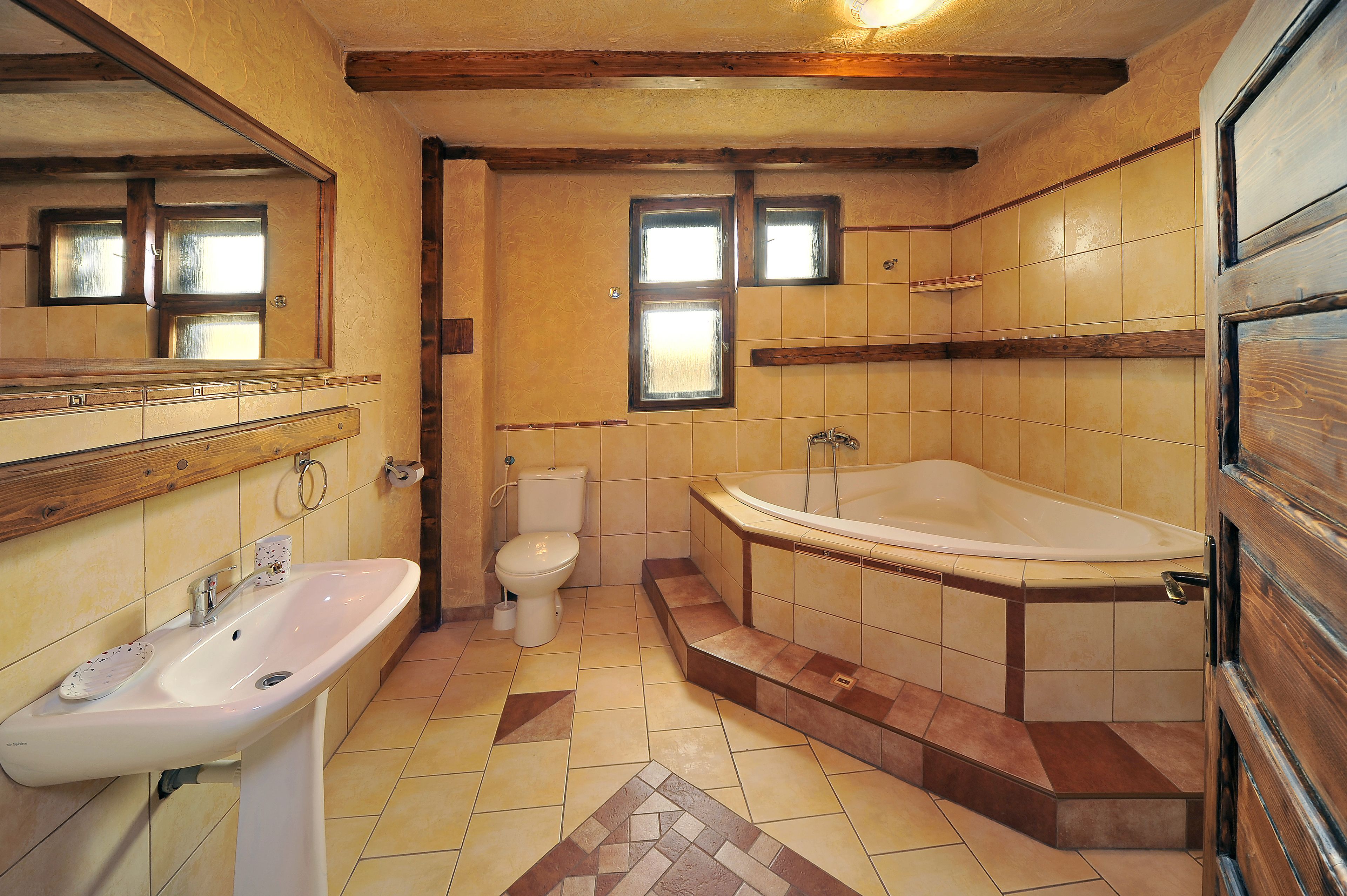 A bathroom with a sink, toilet, and bathtub.