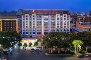 A multi-story hotel with a prominent entrance, large windows, and a well-lit facade. - Hongchanglong Hotel (Nanning)