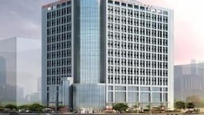 A modern high-rise building with a glass facade and a visible corporate logo at the top. - Ramada Plaza by Wyndham Changsha South (Changsha)