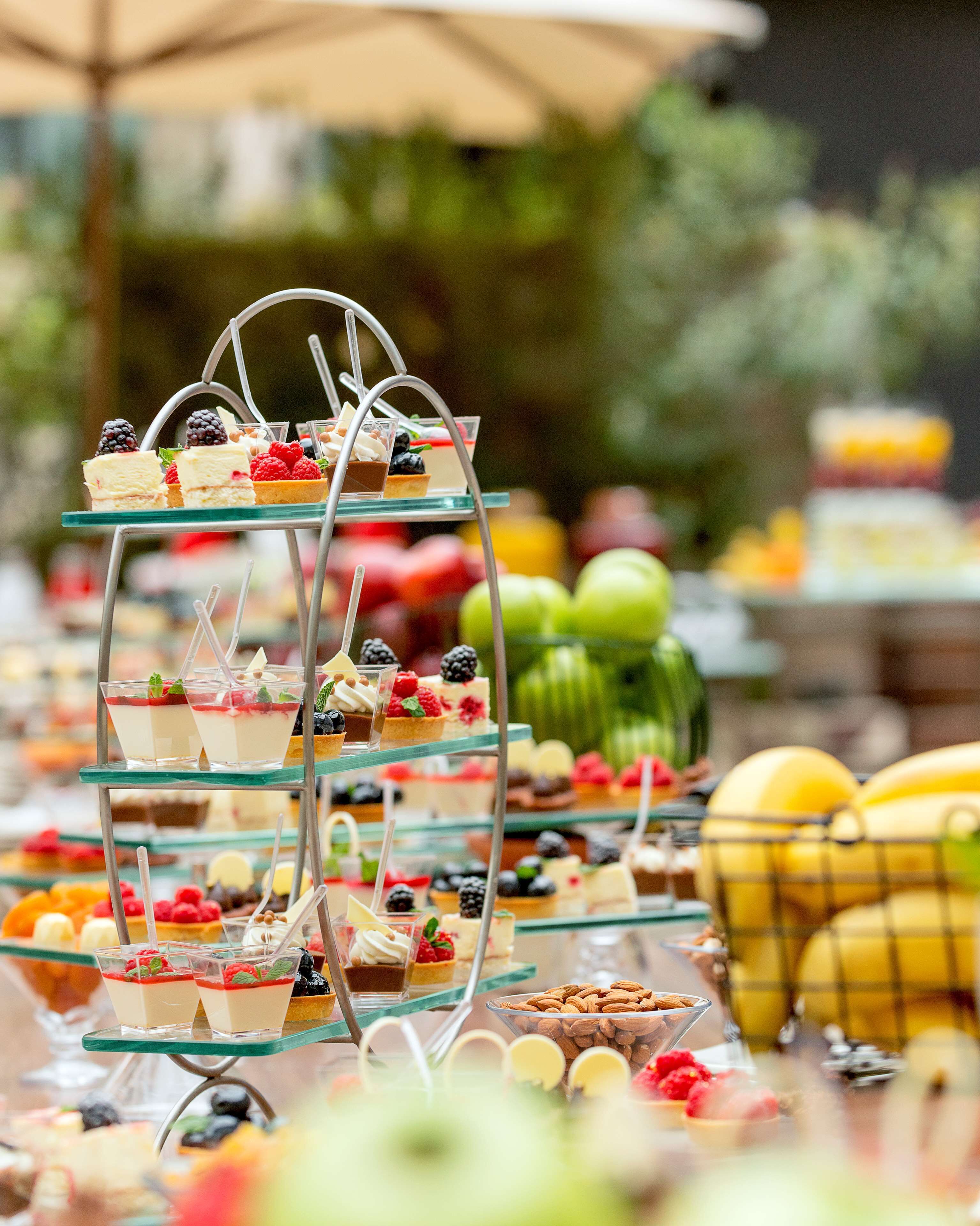 A multi-tiered dessert stand with various sweet treats.