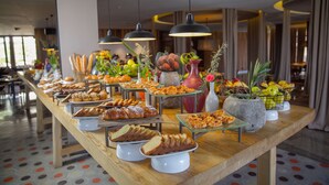 A buffet with various food items and decorative plants. - Radisson Blu Hotel, Marrakech Carré Eden (Marrakech)