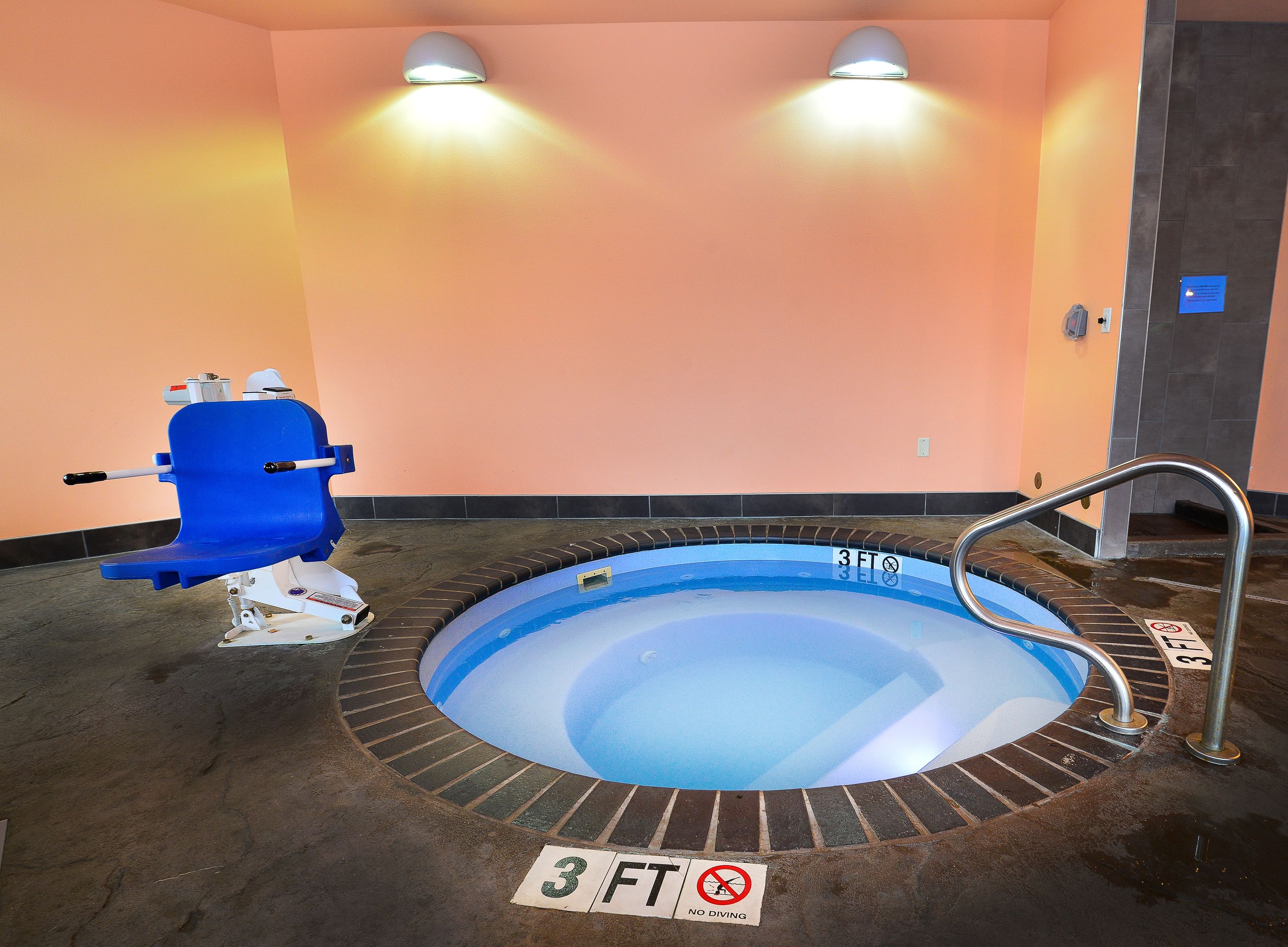 A small indoor pool with a 3 FT depth limit and a no diving sign.