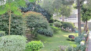 A well-maintained garden with various plants and a small pond. - Hotel Ritz Plaza (Amritsar)
