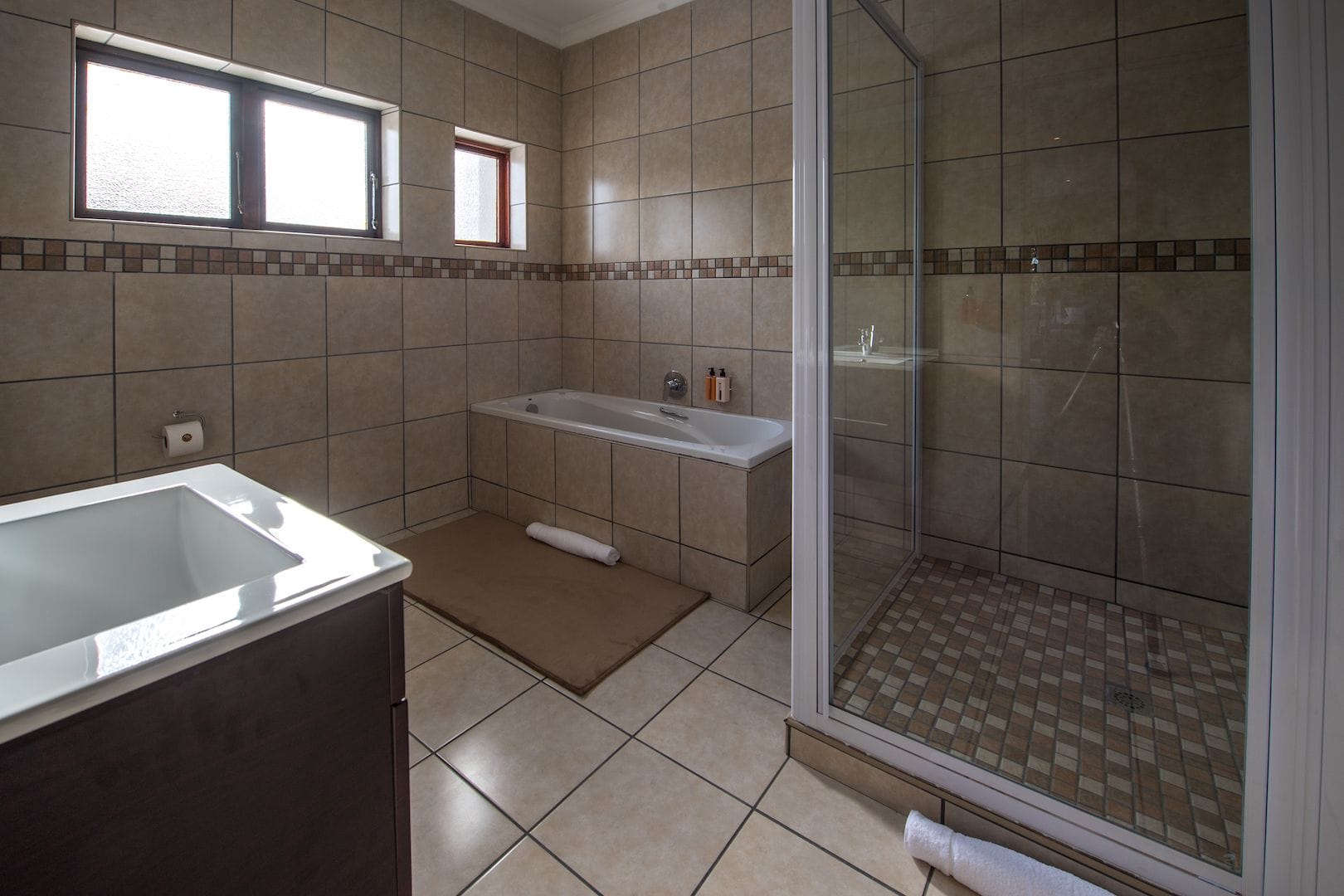 A bathroom with a bathtub, a shower, and a sink.
