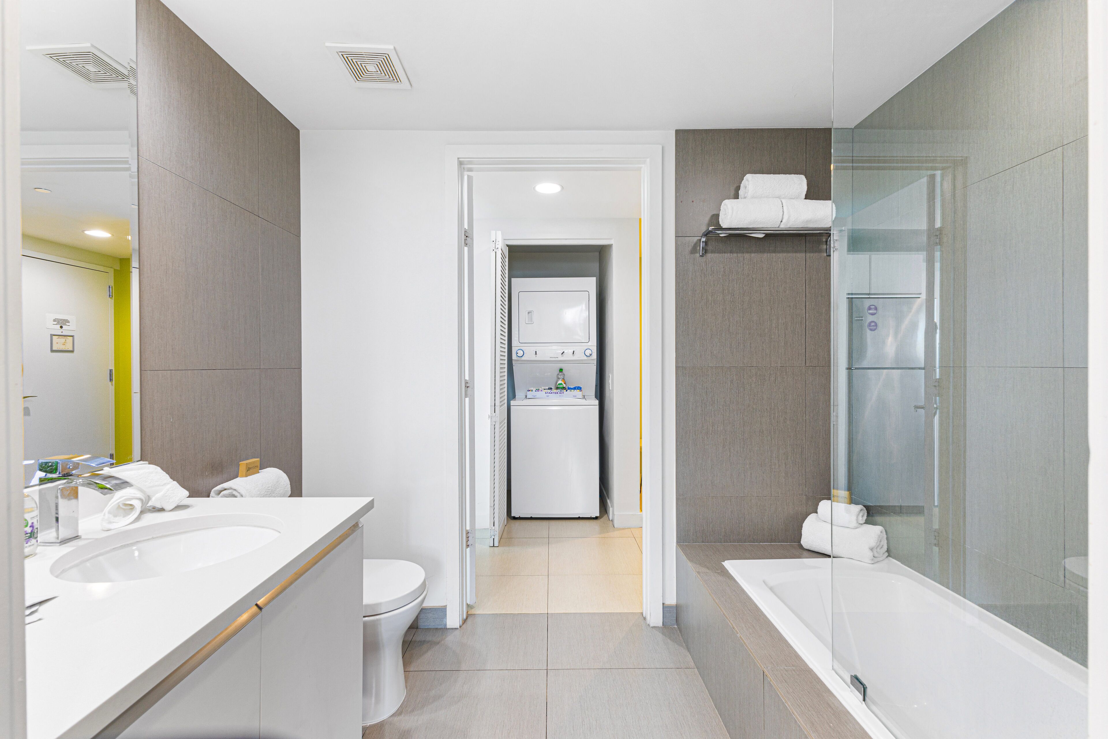 A modern bathroom with a large bathtub, a separate shower area, and a toilet.