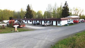 A motel with multiple rooms, a parking area, and a small building with a red roof. - Cataline Motel & RV Park (South Hazelton)