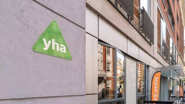 A building with a green triangular sign with the letters "yha" on it. - YHA London Central - Hostel (London)