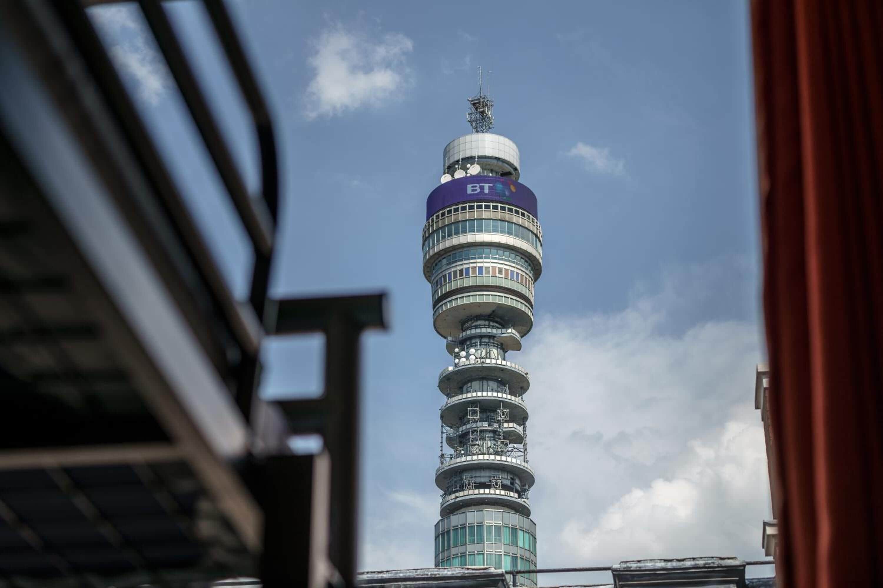 A tall tower with a circular design and a sign reading "BT".