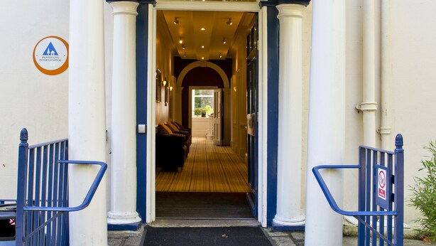 A building entrance with a covered porch, steps leading up to it, and a sign indicating no parking. - YHA Penzance - Hostel (Penzance)