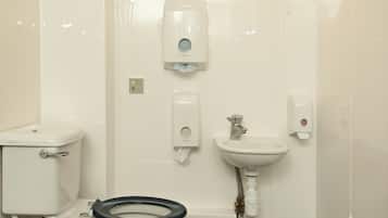 A bathroom with a toilet, bidet, and sink.